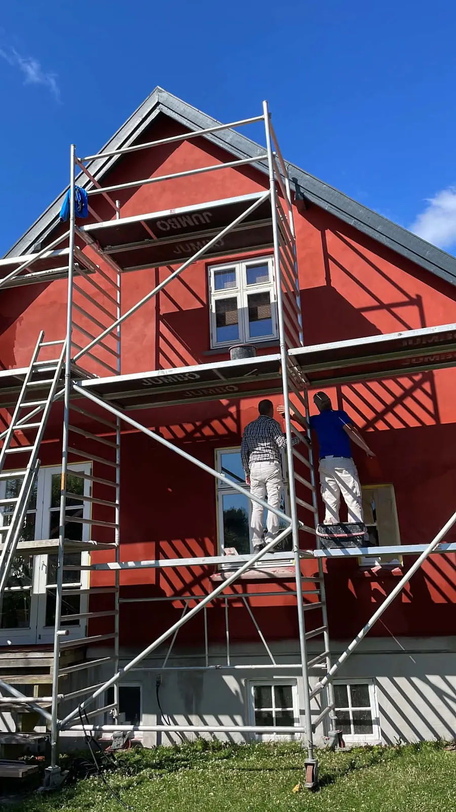 Rød facade under udvendigt malerarbejde